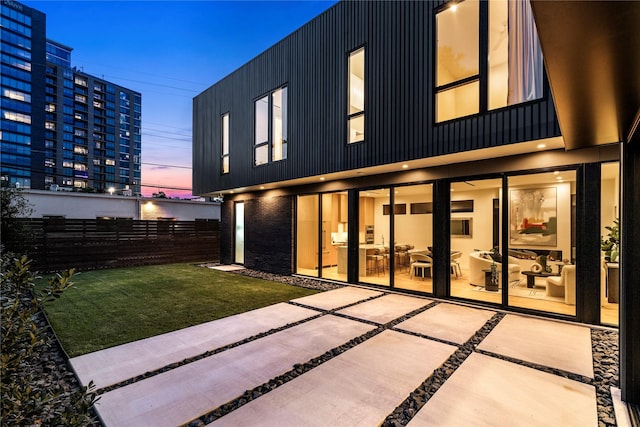 5029 Pershing St, Dallas, TX 75206 - back of house at dusk with a patio area