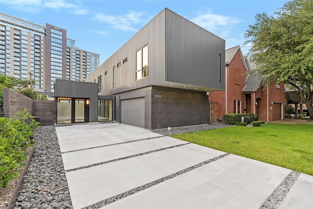 5029 Pershing St, Dallas, TX 75206 - contemporary house featuring an attached garage, brick siding, concrete driveway, and a front lawn