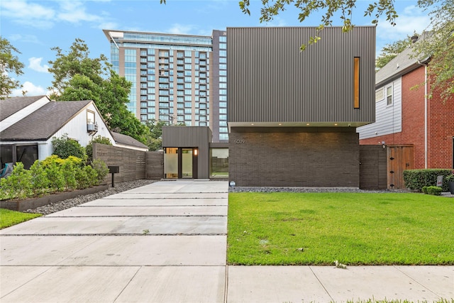 5029 Pershing St, Dallas, TX 75206 - contemporary house with concrete driveway, a gate, and brick siding