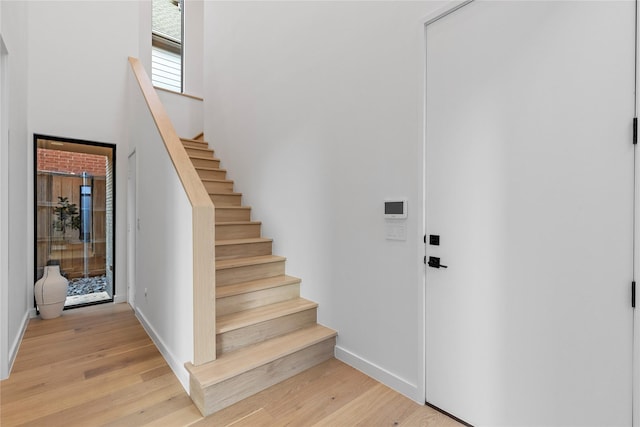5029 Pershing St, Dallas, TX 75206 - foyer featuring stairway, light wood-style flooring, baseboards, and a high ceiling