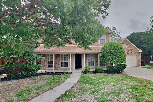 1701 Shiprock Dr, Plano, TX 75025 - obstructed view of property with covered porch, driveway, brick siding, and a garage