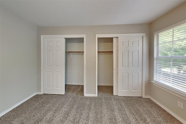 1701 Shiprock Dr, Plano, TX 75025 - unfurnished bedroom with carpet flooring, two closets, and baseboards
