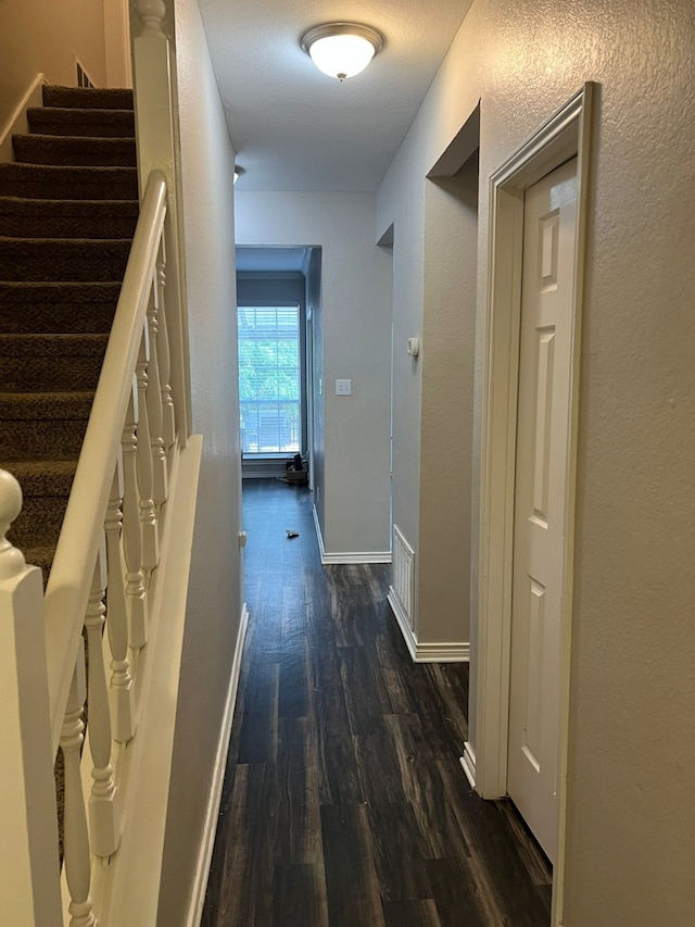 1701 Shiprock Dr, Plano, TX 75025 - hallway with dark wood finished floors, baseboards, and stairs