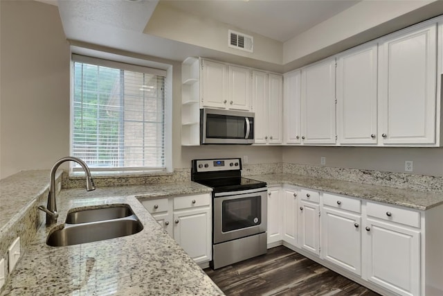 1701 Shiprock Dr, Plano, TX 75025 - kitchen with stainless steel appliances, a sink, open shelves, white cabinets, and dark wood-style floors
