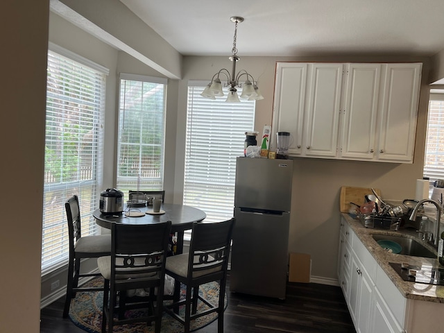 1701 Shiprock Dr, Plano, TX 75025 - dining space featuring a chandelier, baseboards, and dark wood finished floors