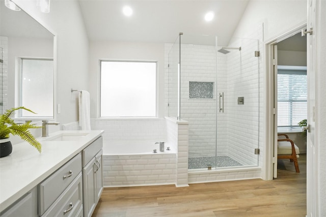 211 Windsong Way, Allen, TX 75002 - bathroom featuring vanity, lofted ceiling, a bath, a stall shower, and wood finished floors