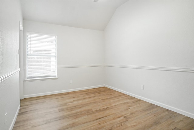 211 Windsong Way, Allen, TX 75002 - empty room featuring lofted ceiling, light wood-type flooring, and baseboards