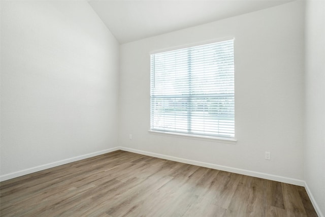 211 Windsong Way, Allen, TX 75002 - spare room featuring vaulted ceiling, light wood-type flooring, and baseboards