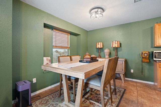 419 NW Murphy Rd, Burleson, TX 76028 - dining space featuring a textured wall and baseboards