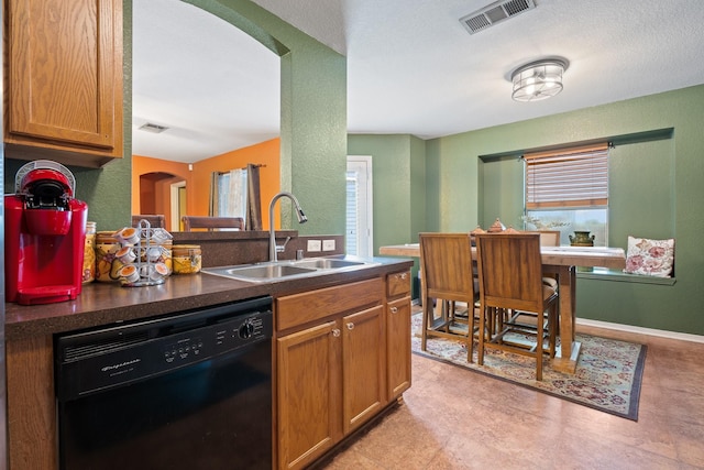 419 NW Murphy Rd, Burleson, TX 76028 - kitchen with dishwasher, arched walkways, dark countertops, and brown cabinets