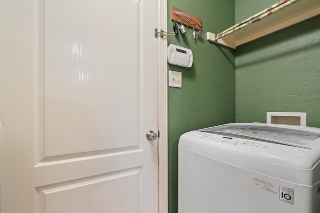 419 NW Murphy Rd, Burleson, TX 76028 - washroom with washer / dryer and a textured wall
