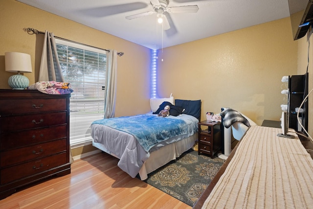 419 NW Murphy Rd, Burleson, TX 76028 - bedroom featuring wood finished floors and a ceiling fan