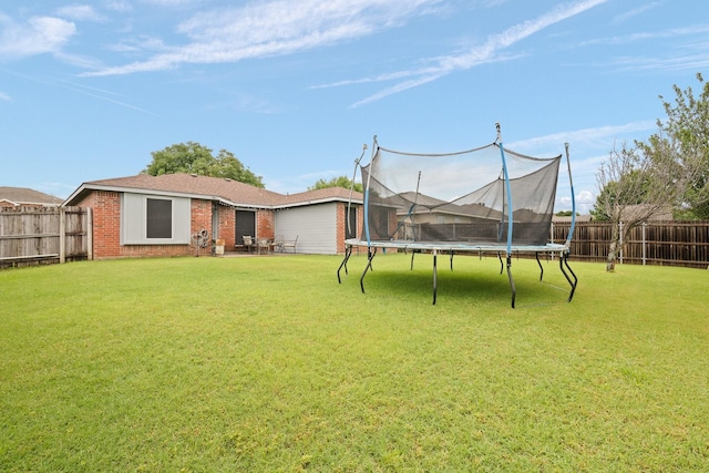 419 NW Murphy Rd, Burleson, TX 76028 - fenced backyard featuring a trampoline