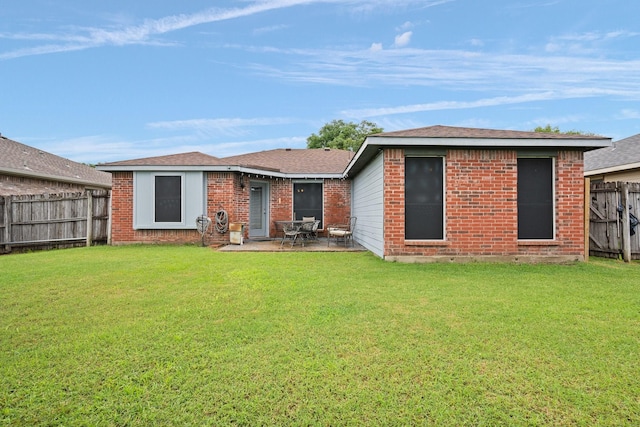 419 NW Murphy Rd, Burleson, TX 76028 - rear view of property featuring a fenced backyard, brick siding, and a patio area