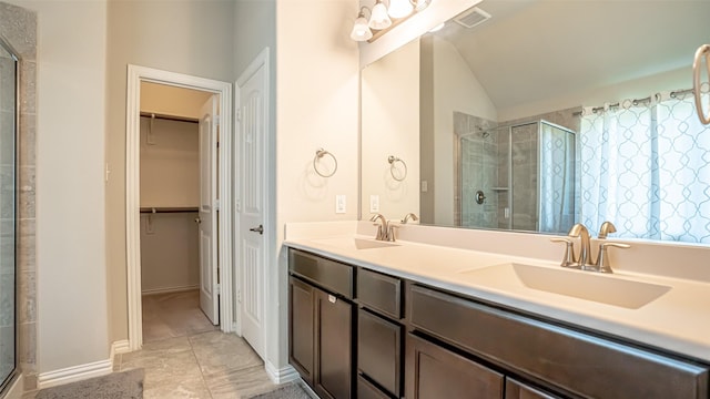 4100 Fanita Pl, Denton, TX 76210 - bathroom with vaulted ceiling, a stall shower, double vanity, and a walk in closet