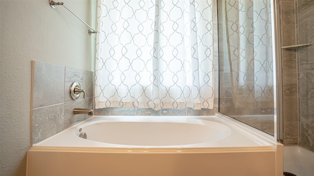 4100 Fanita Pl, Denton, TX 76210 - bathroom featuring a textured wall and a garden tub