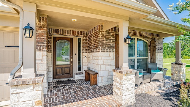 4100 Fanita Pl, Denton, TX 76210 - view of exterior entry with covered porch, stone siding, and brick siding