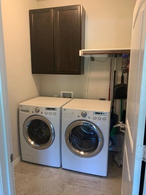 4100 Fanita Pl, Denton, TX 76210 - washroom featuring independent washer and dryer, cabinet space, and light tile patterned flooring