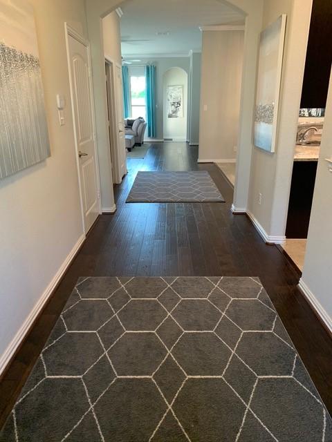 4100 Fanita Pl, Denton, TX 76210 - corridor with hardwood / wood-style flooring, arched walkways, baseboards, a sink, and crown molding