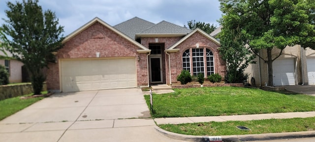 301 Crepe Myrtle Dr, Euless, TX 76039 - view of front of house with driveway, a front lawn, brick siding, and an attached garage