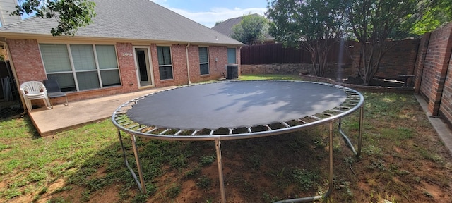 301 Crepe Myrtle Dr, Euless, TX 76039 - fenced backyard featuring a trampoline and a patio