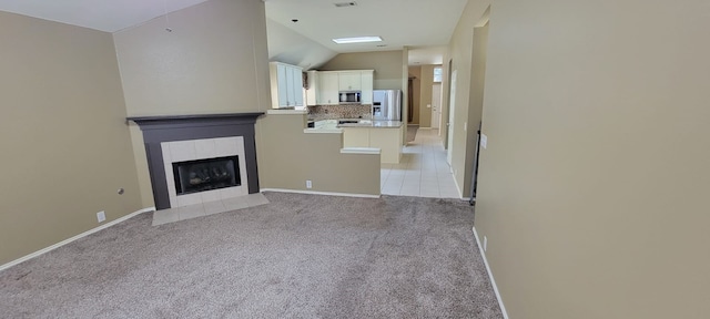 301 Crepe Myrtle Dr, Euless, TX 76039 - unfurnished living room with light carpet, a fireplace, and lofted ceiling