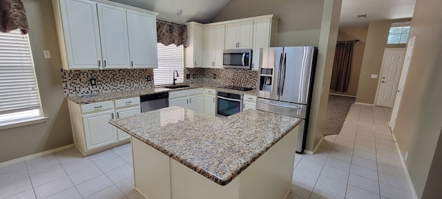 301 Crepe Myrtle Dr, Euless, TX 76039 - kitchen with appliances with stainless steel finishes, healthy amount of natural light, tasteful backsplash, light tile patterned floors, and lofted ceiling