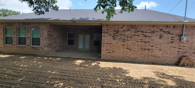 1305 Dewberry Dr, Wilmer, TX 75172 - back of house with brick siding, a patio, and roof with shingles