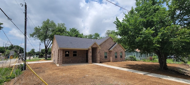 1305 Dewberry Dr, Wilmer, TX 75172 - view of front facade with brick siding and a shingled roof