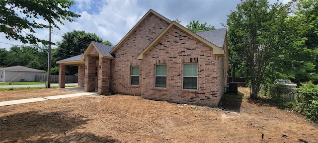 1305 Dewberry Dr, Wilmer, TX 75172 - view of front facade with brick siding and central air condition unit