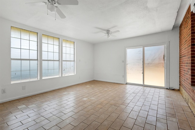 8109 Dripping Springs Dr, Fort Worth, TX 76134 - spare room featuring ceiling fan, baseboards, and brick wall