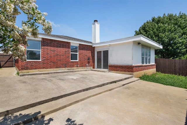 8109 Dripping Springs Dr, Fort Worth, TX 76134 - back of property featuring brick siding, a patio area, and a chimney