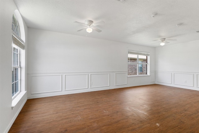 8109 Dripping Springs Dr, Fort Worth, TX 76134 - spare room featuring ceiling fan, a textured ceiling, wood finished floors, a decorative wall, and a smoke detector