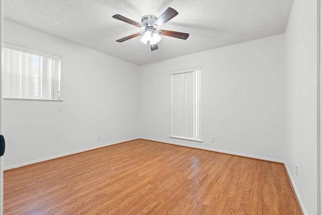 108 Mockingbird Ln, Hillsboro, TX 76645 - unfurnished room featuring light wood-style flooring, ceiling fan, a textured ceiling, and baseboards