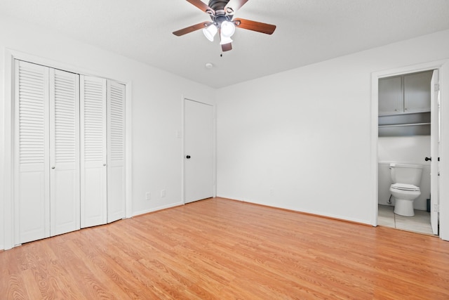108 Mockingbird Ln, Hillsboro, TX 76645 - unfurnished bedroom featuring light wood finished floors, connected bathroom, baseboards, and a ceiling fan