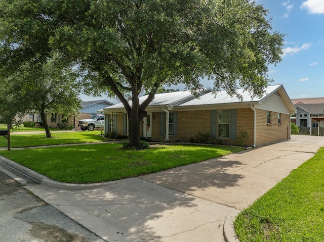 108 Mockingbird Ln, Hillsboro, TX 76645 - single story home featuring a front lawn, concrete driveway, brick siding, and metal roof