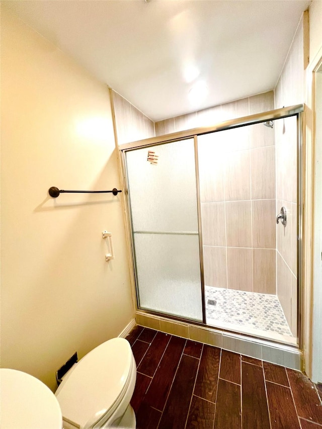 404 Westway Dr, Rockwall, TX 75087 - bathroom with toilet, a shower stall, and wood finish floors