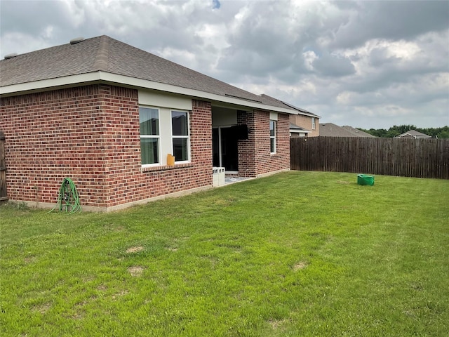 304 Gypsum Ln, Glenn Heights, TX 75154 - back of house featuring brick siding and roof with shingles