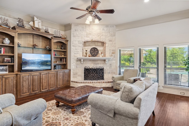 499 Savannah Hill Ln, Rockwall, TX 75032 - living area with ornamental molding, dark wood-style flooring, a ceiling fan, and a large fireplace