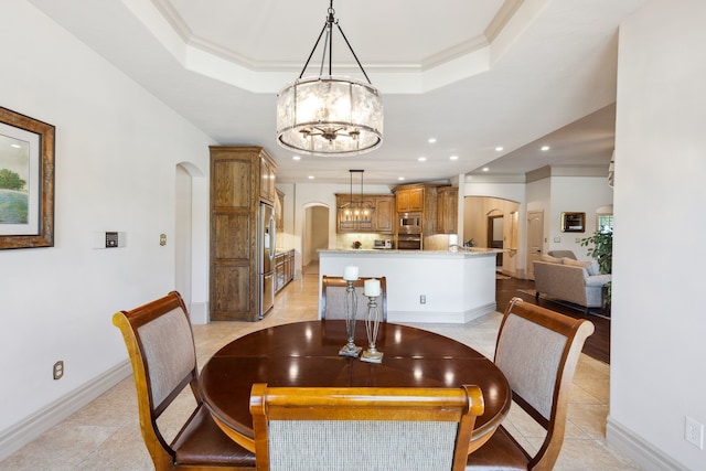499 Savannah Hill Ln, Rockwall, TX 75032 - dining space featuring arched walkways, a chandelier, a raised ceiling, recessed lighting, and crown molding