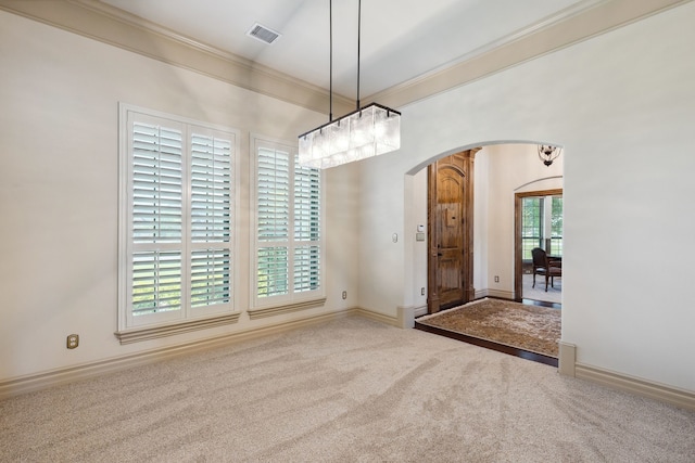 499 Savannah Hill Ln, Rockwall, TX 75032 - carpeted spare room featuring arched walkways, ornamental molding, baseboards, and a chandelier