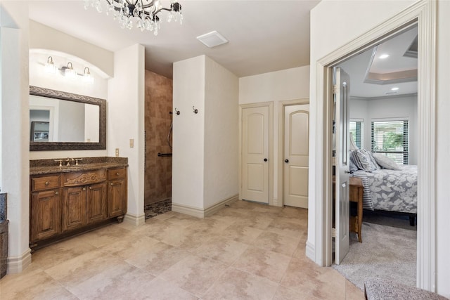 499 Savannah Hill Ln, Rockwall, TX 75032 - ensuite bathroom with walk in shower, vanity, a chandelier, and a raised ceiling