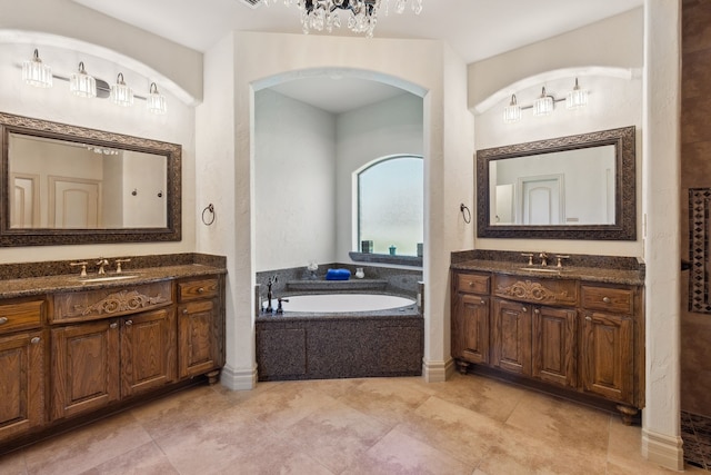 499 Savannah Hill Ln, Rockwall, TX 75032 - full bath with a garden tub, two vanities, a chandelier, and tile patterned flooring