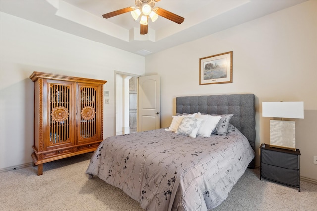 499 Savannah Hill Ln, Rockwall, TX 75032 - bedroom with light carpet, a tray ceiling, ceiling fan, and baseboards