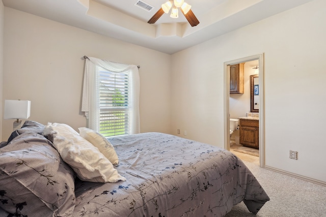 499 Savannah Hill Ln, Rockwall, TX 75032 - bedroom with light colored carpet, ensuite bath, a ceiling fan, a tray ceiling, and baseboards