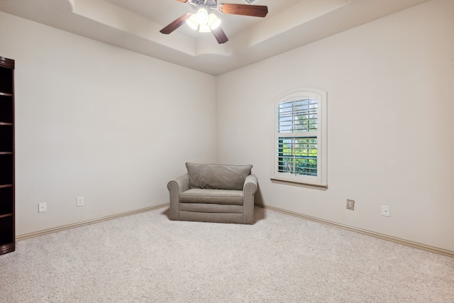 499 Savannah Hill Ln, Rockwall, TX 75032 - living area featuring a tray ceiling, carpet floors, a ceiling fan, and baseboards