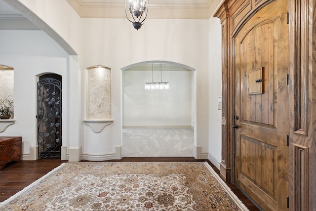 499 Savannah Hill Ln, Rockwall, TX 75032 - entrance foyer with arched walkways, dark wood-style floors, baseboards, and ornamental molding