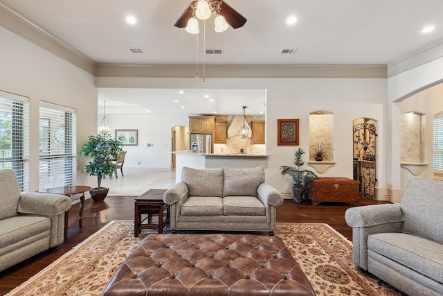 499 Savannah Hill Ln, Rockwall, TX 75032 - living room featuring ceiling fan, wood finished floors, ornamental molding, baseboards, and arched walkways