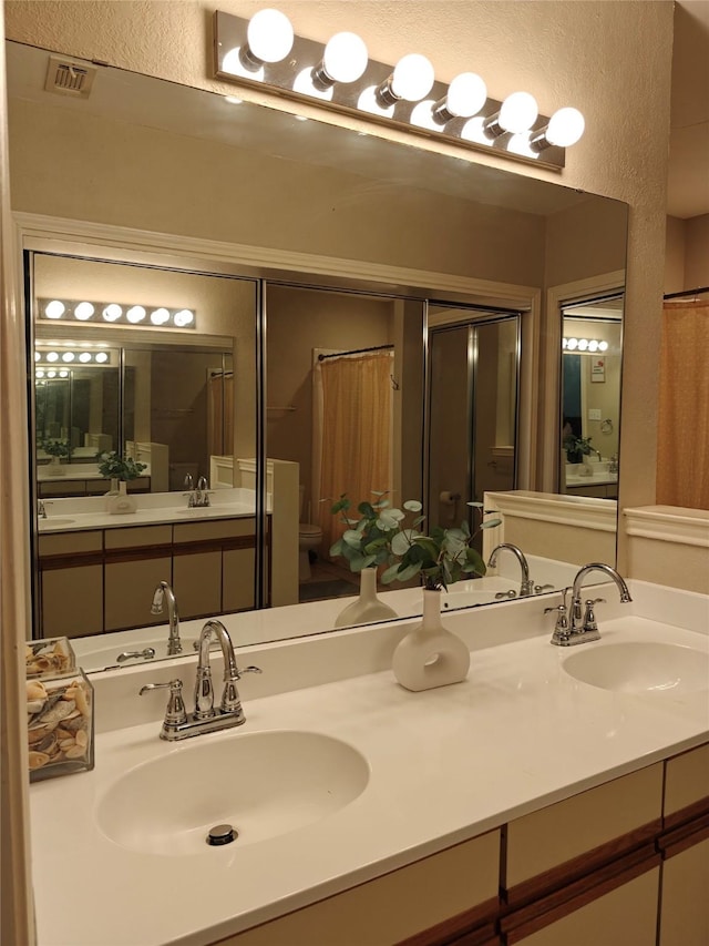 5309 San Mateo Ct, Arlington, TX 76017 - full bathroom with toilet, double vanity, and a shower with shower curtain