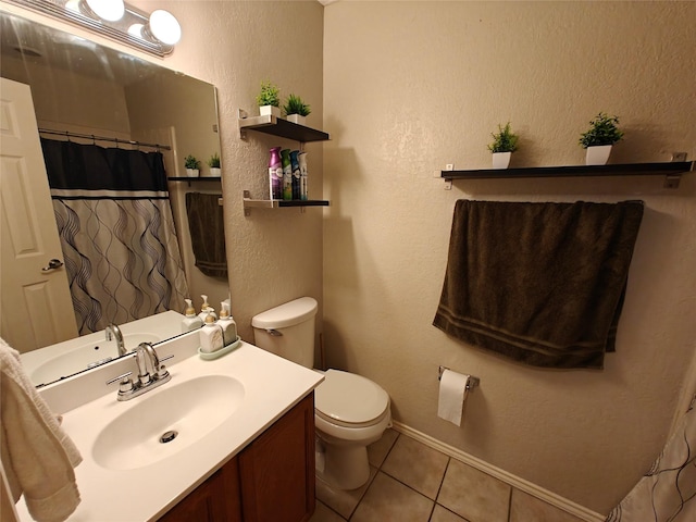 5309 San Mateo Ct, Arlington, TX 76017 - full bathroom featuring tile patterned flooring, vanity, toilet, a textured wall, and baseboards